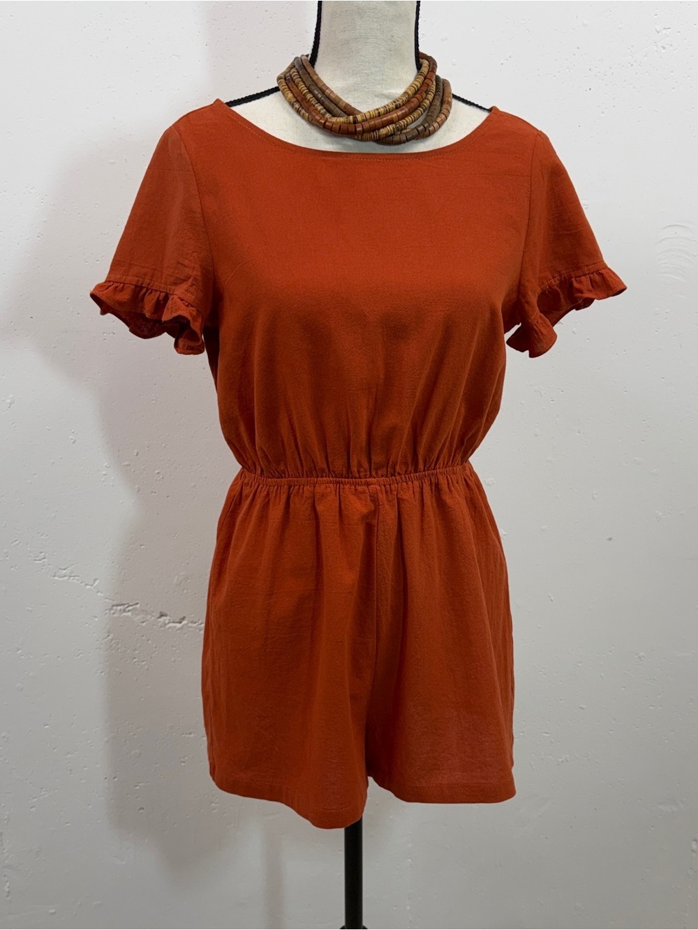 Rust Short Sleeve Romper in size 4. In a textured fabric